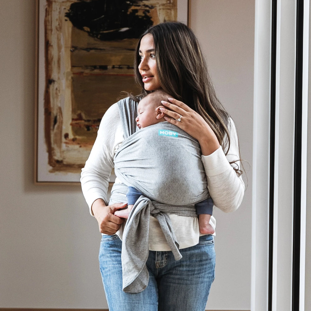 mom wearing baby in moby classic wrap in gray