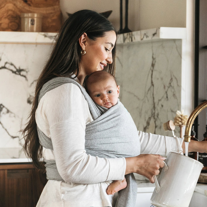 mom wearing baby in moby classic wrap in gray