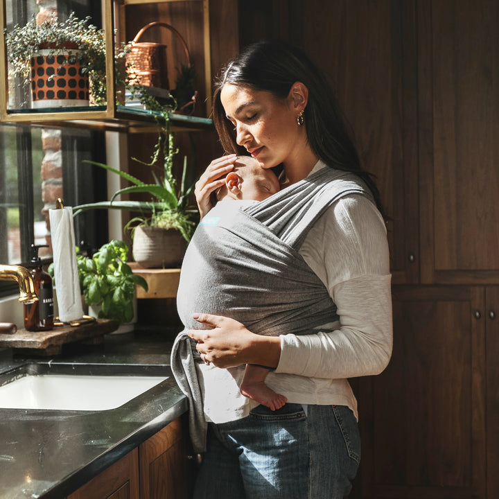 mom wearing baby in moby classic wrap in gray