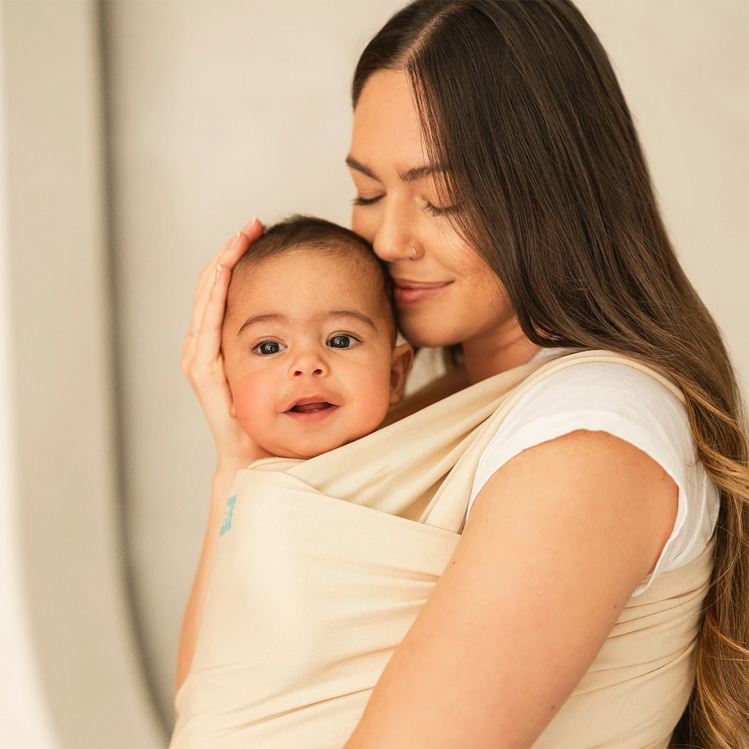 mom wearing baby in Classic Wrap Baby Carrier in Sand Dollar