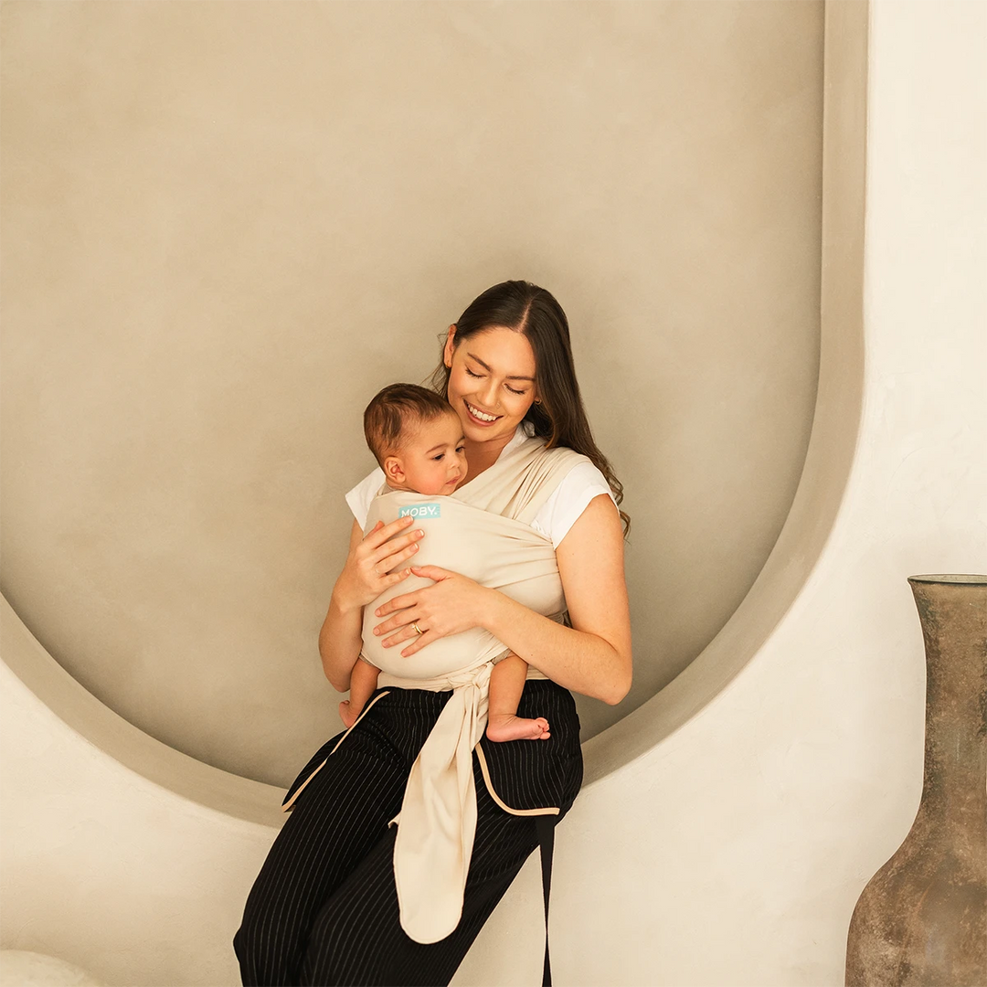 mom wearing baby in Classic Wrap Baby Carrier in Sand Dollar