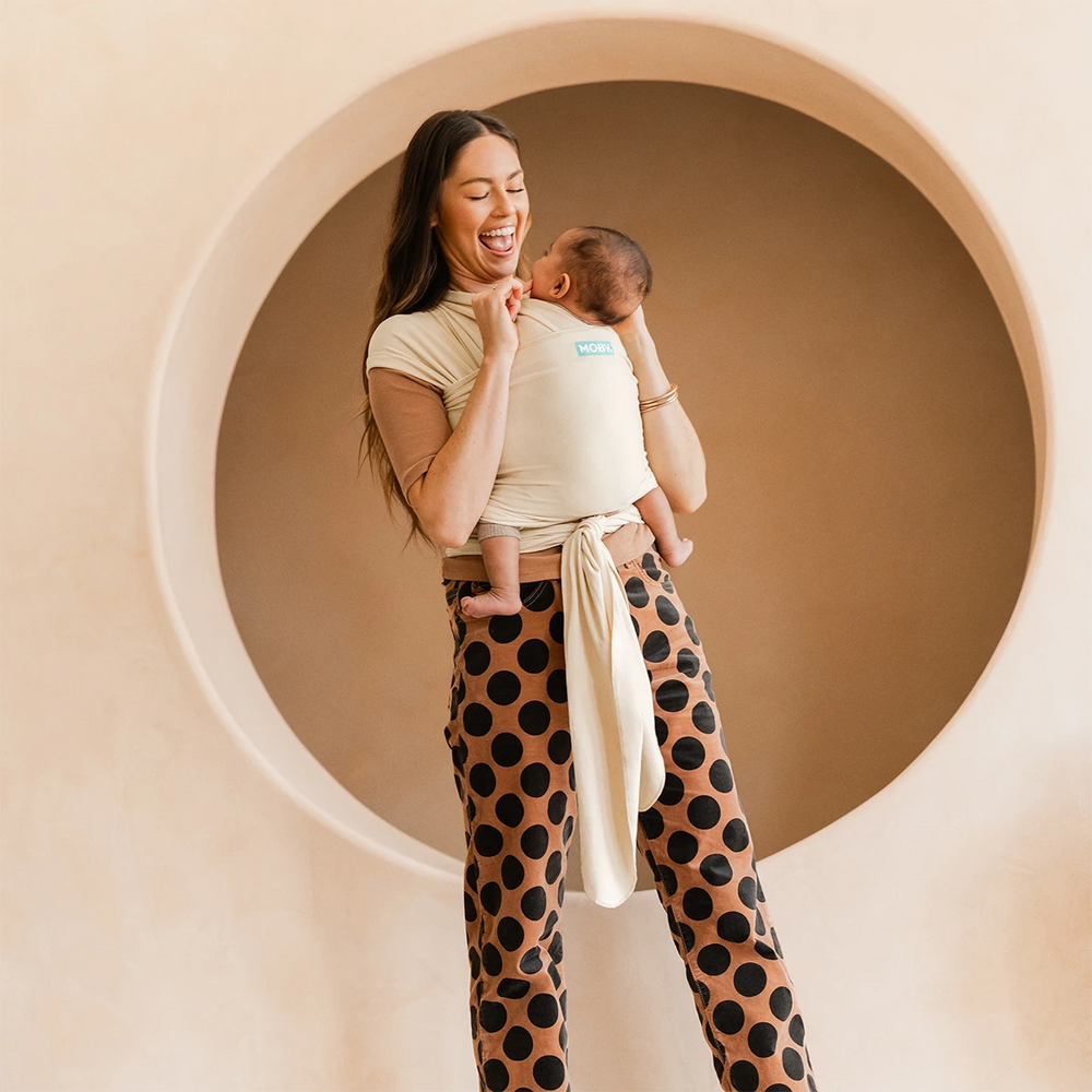 mom wearing baby in Classic Wrap Baby Carrier in Sand Dollar