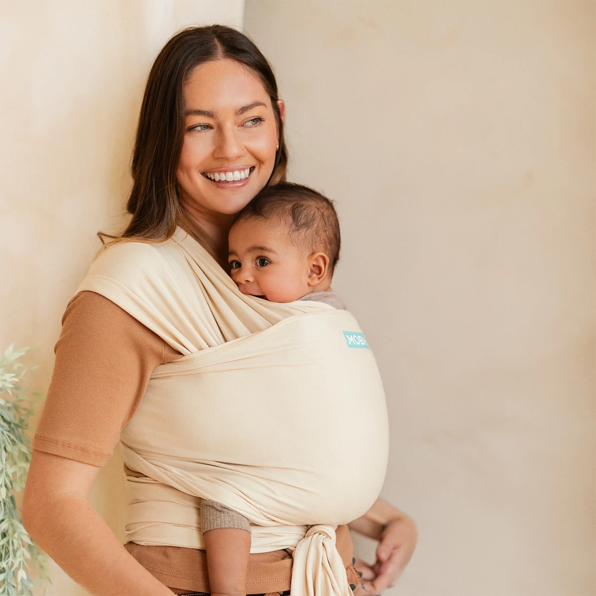 mom wearing baby in Classic Wrap Baby Carrier in Sand Dollar