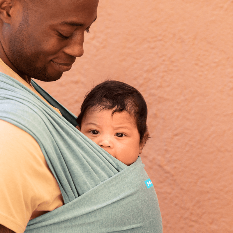 dad wearing baby in elements wrap in hydro