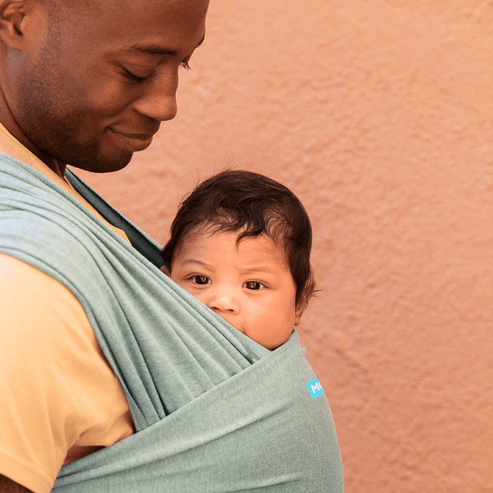 dad wearing baby in elements wrap in hydro