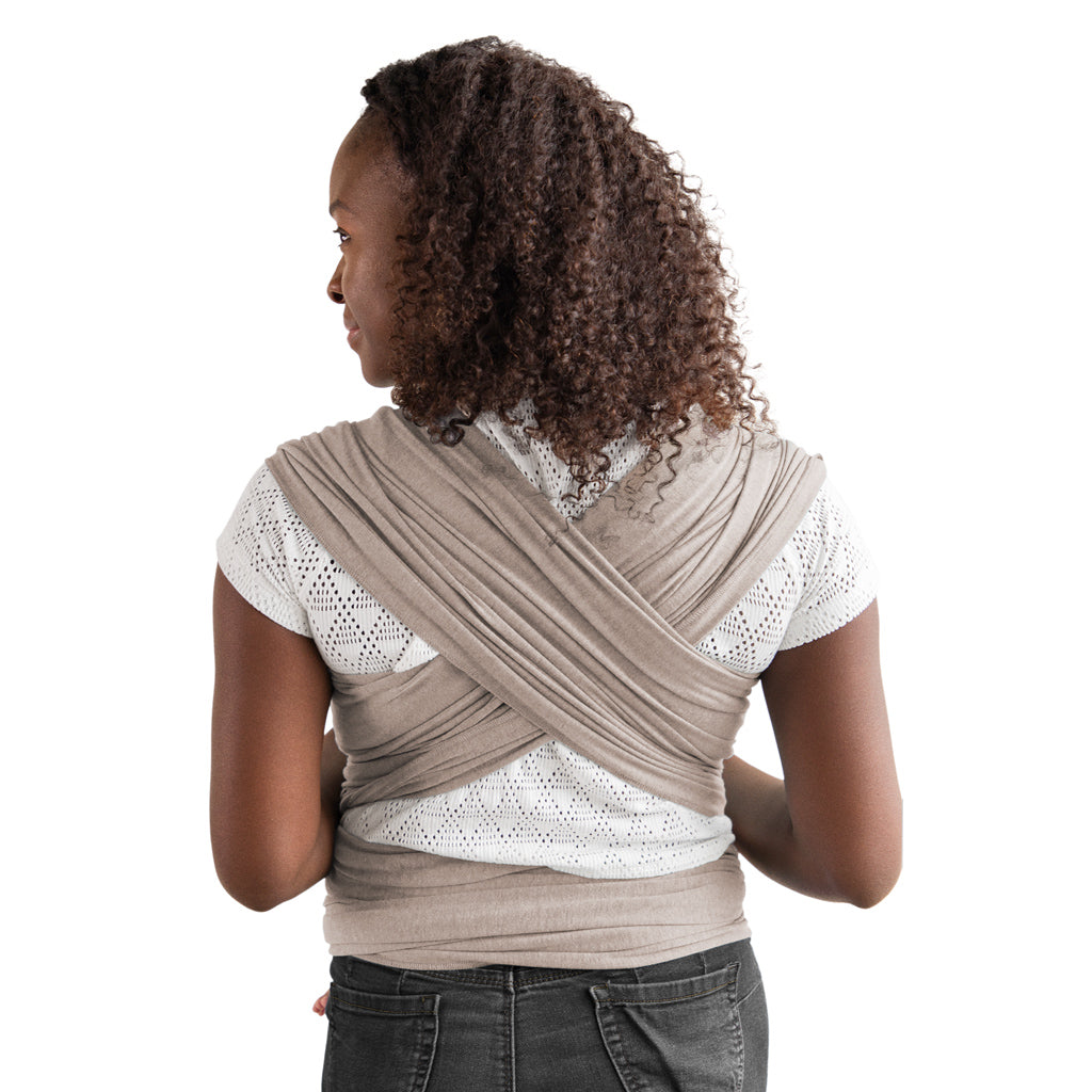 back image of mom wearing baby in elements wrap in taupe