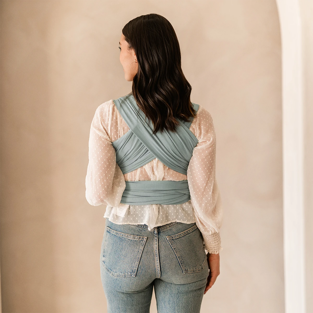 back image of mom wearing baby in MOBY Wrap Evolution in Sea Glass