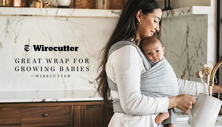 great wrap for growing babies by wirecutter. mom wearing baby in moby wrap in grey