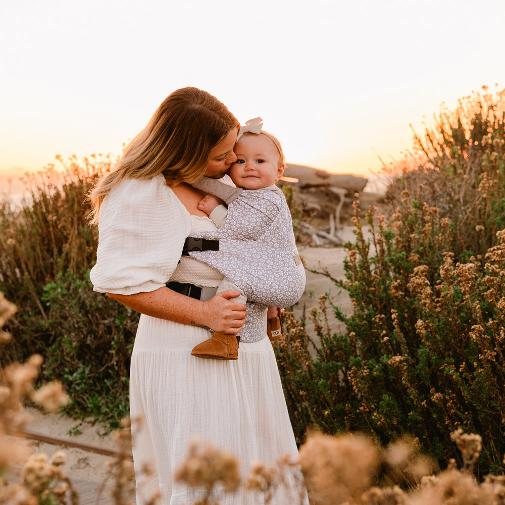 mom wearing baby in the duet carrier in prairie blooms