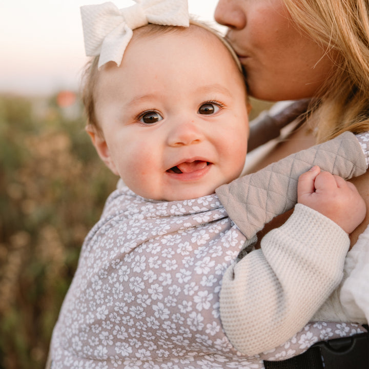 mom wearing baby in the duet carrier in prairie blooms