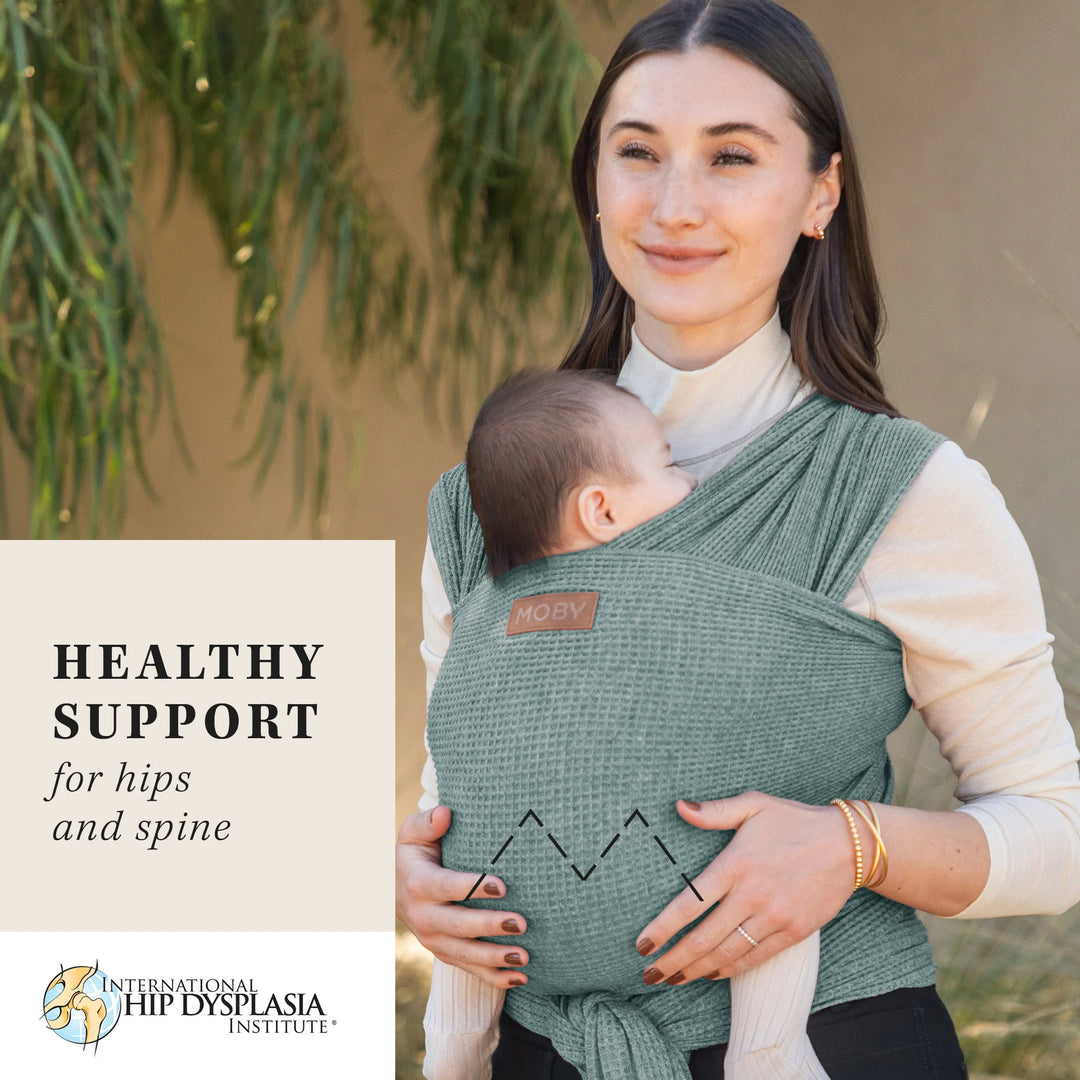 mom wearing baby in waffle knit wrap in saguaro. healthy support for hips and spine from the international hip dysplasia institute.