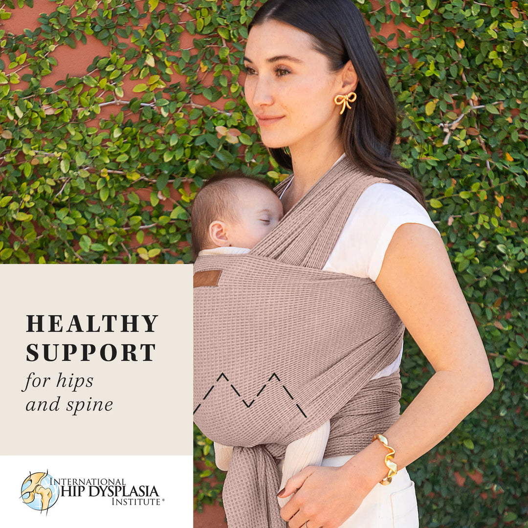 mom wearing baby in waffle knit wrap in saguaro. healthy support for hips and spine from the international hip dysplasia institute.