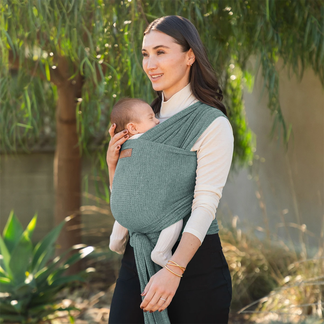mom wearing baby in waffle knit wrap in saguaro