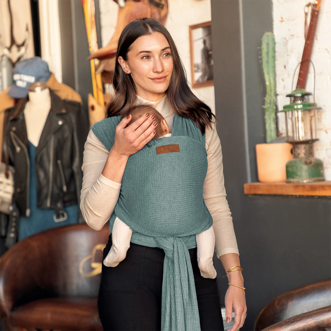 mom wearing baby in waffle knit wrap in saguaro