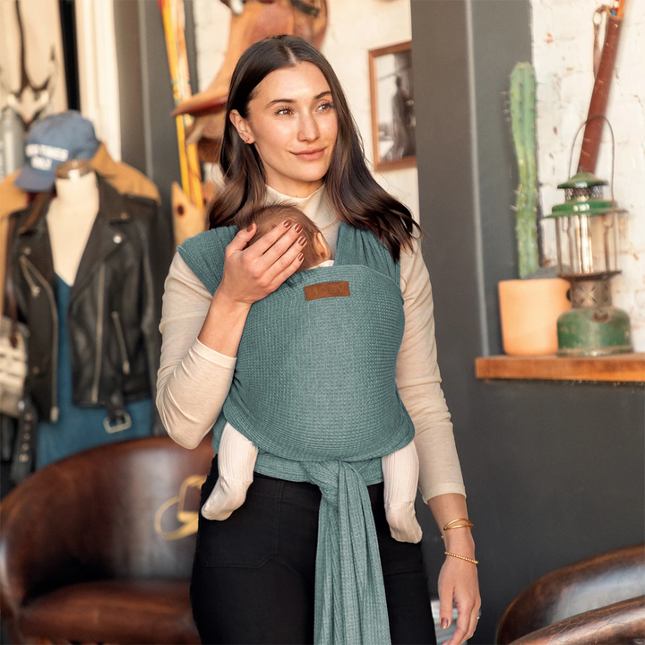 mom wearing baby in waffle knit wrap in saguaro
