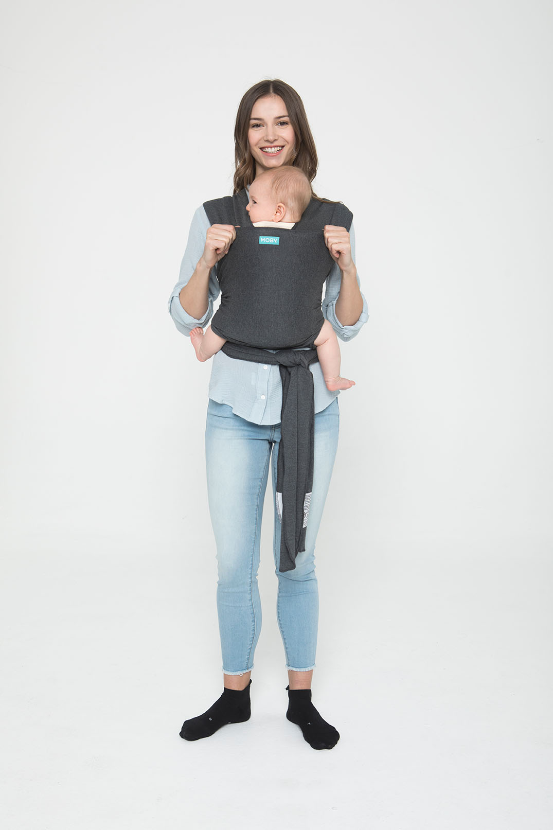 mom wearing baby in moby wrap in gray