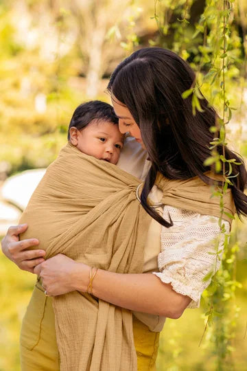 mom wearing baby in ring sling