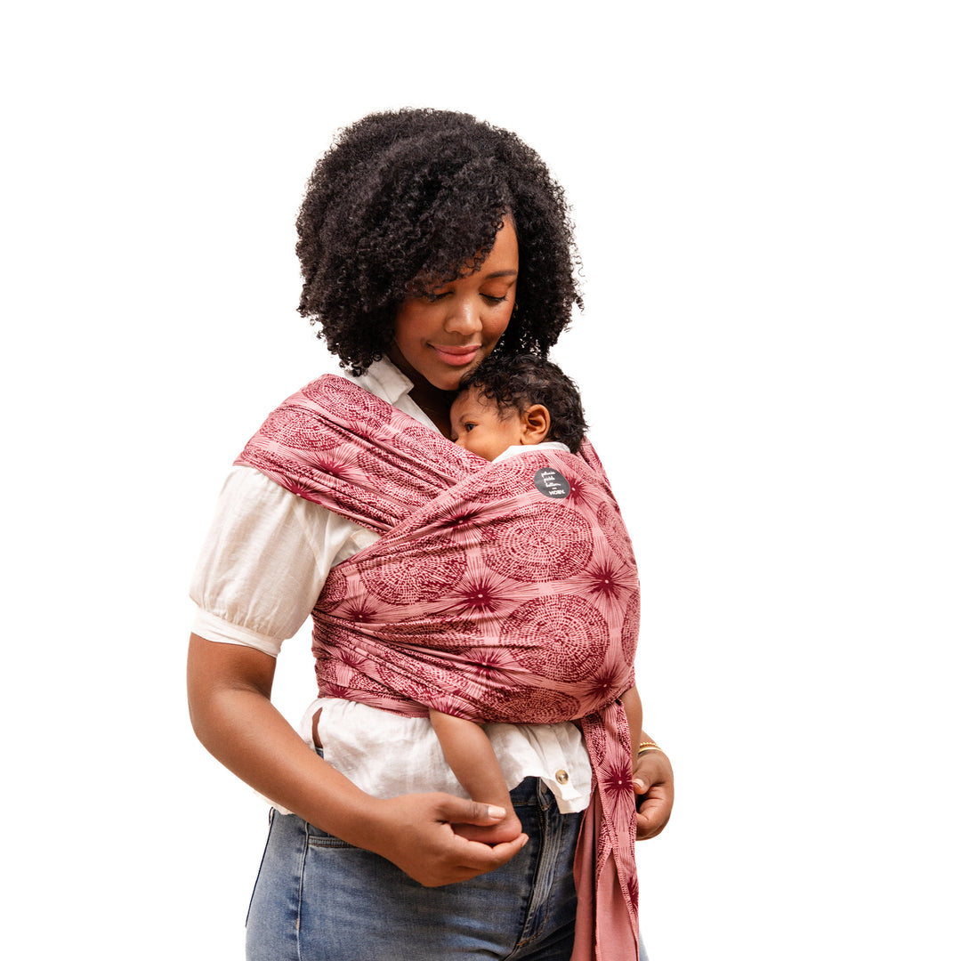 mom wearing the petunia and moby evolution wrap in sunbeam