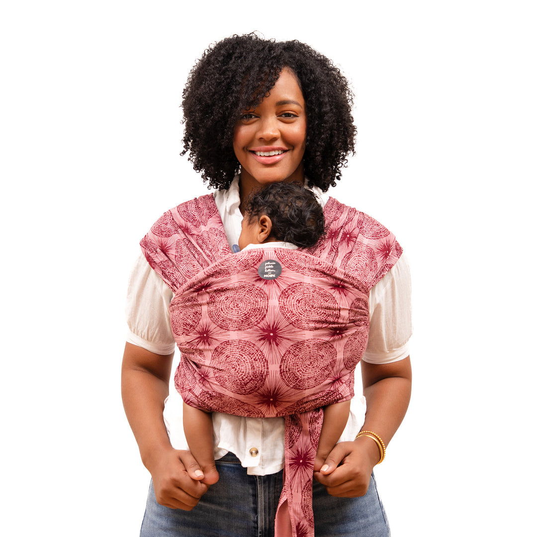mom wearing the petunia and moby evolution wrap in sunbeam