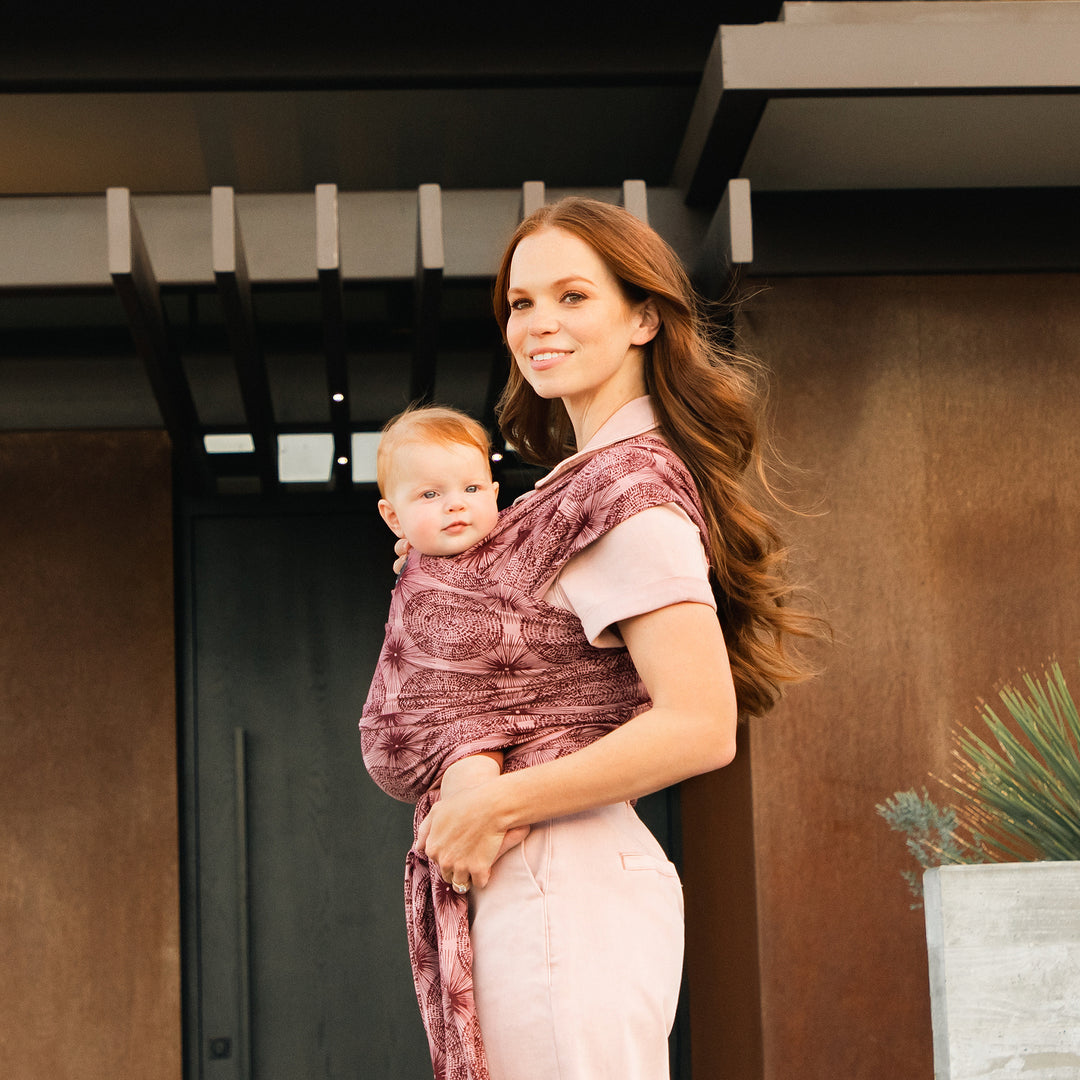 mom wearing the petunia and moby evolution wrap in sunbeam