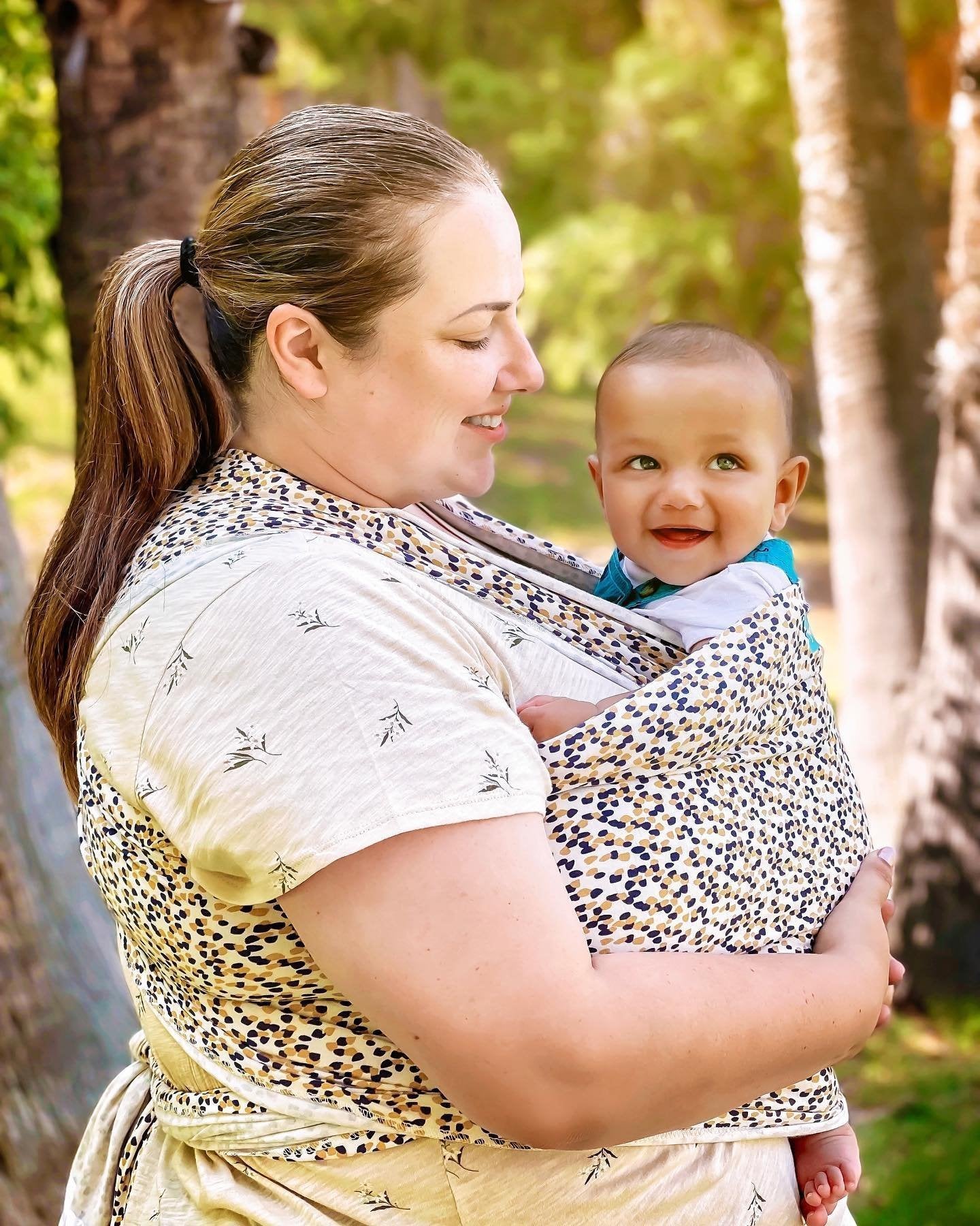 Plus-Size Mom Wearing Baby in Wrap with Tie Secured Around Back