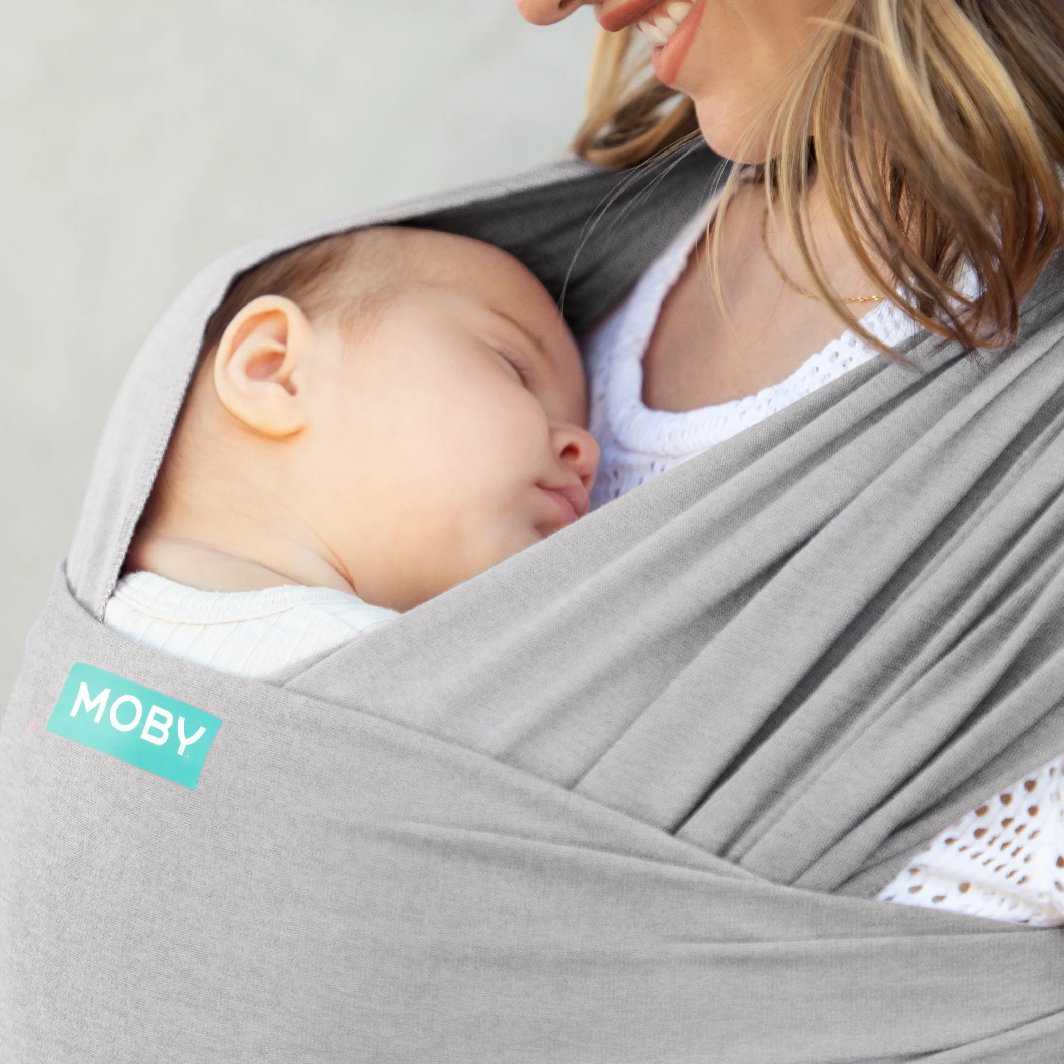 mom wearing baby in moby classic wrap in gray