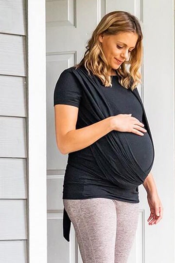 pregnant woman in black shirt wearing a moby wrap