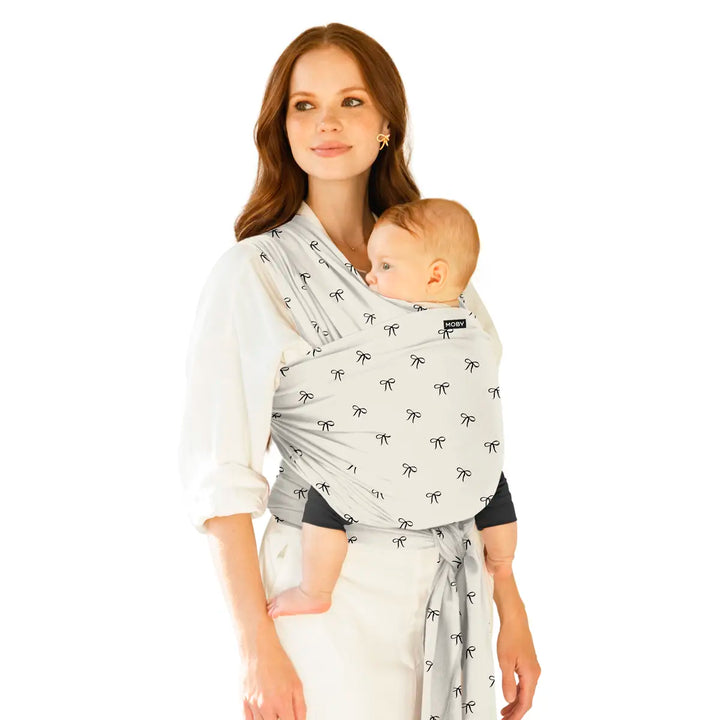 mom wearing baby in Classic Wrap Baby Carrier in Belles & Bows