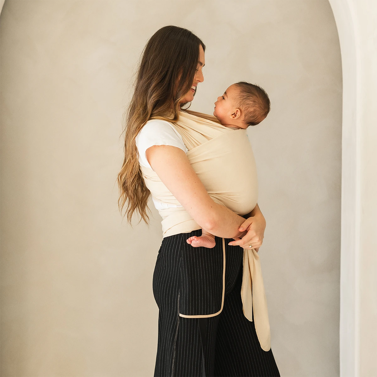 mom wearing baby in Classic Wrap Baby Carrier in Sand Dollar