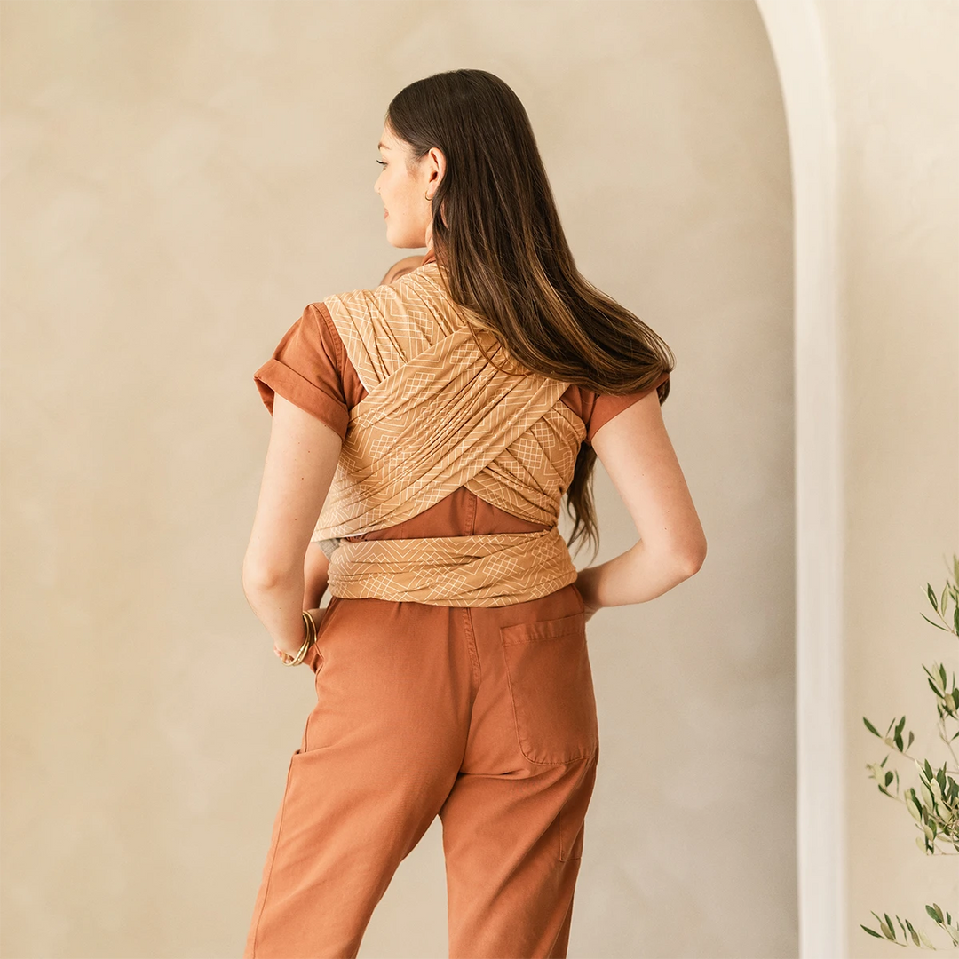 back image of mom wearing baby in Classic Wrap Baby Carrier in Sand Waves