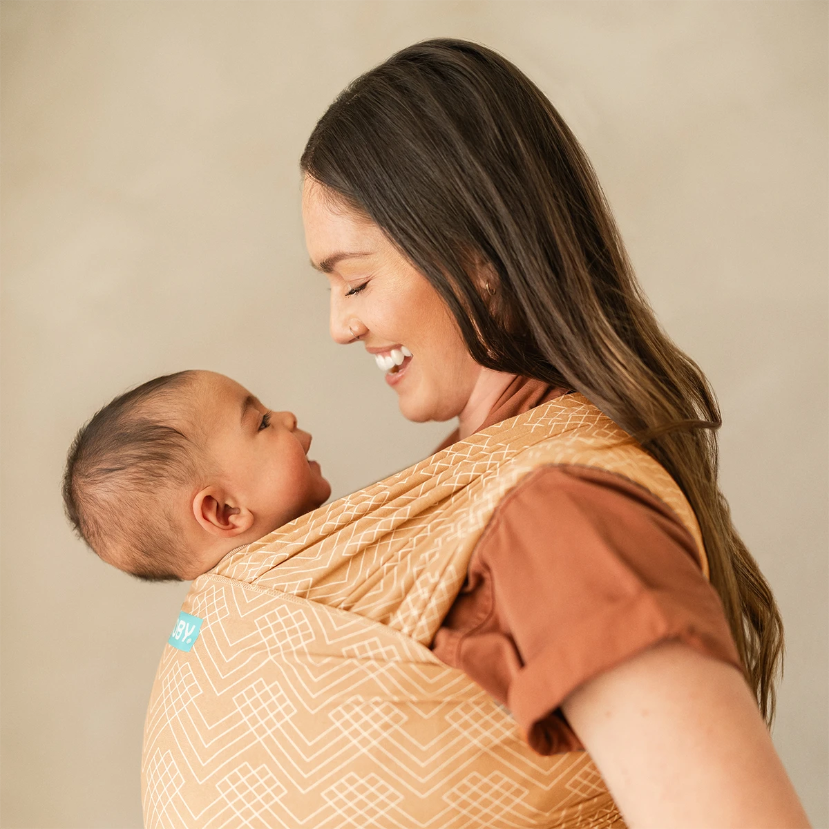 mom wearing baby in Classic Wrap Baby Carrier in Sand Waves