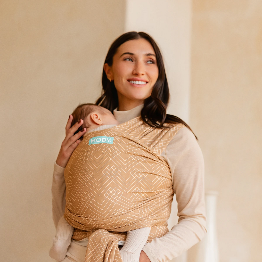 mom wearing baby in Classic Wrap Baby Carrier in Sand Waves