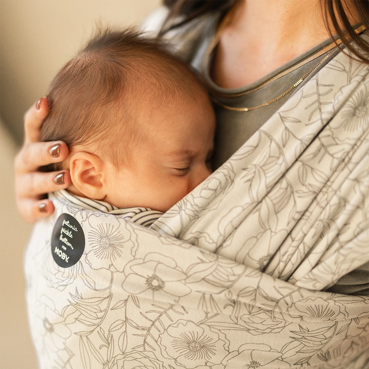 mom wearing baby in Classic Wrap Baby Carrier by Petunia Pickle Bottom in Seaside Poppies