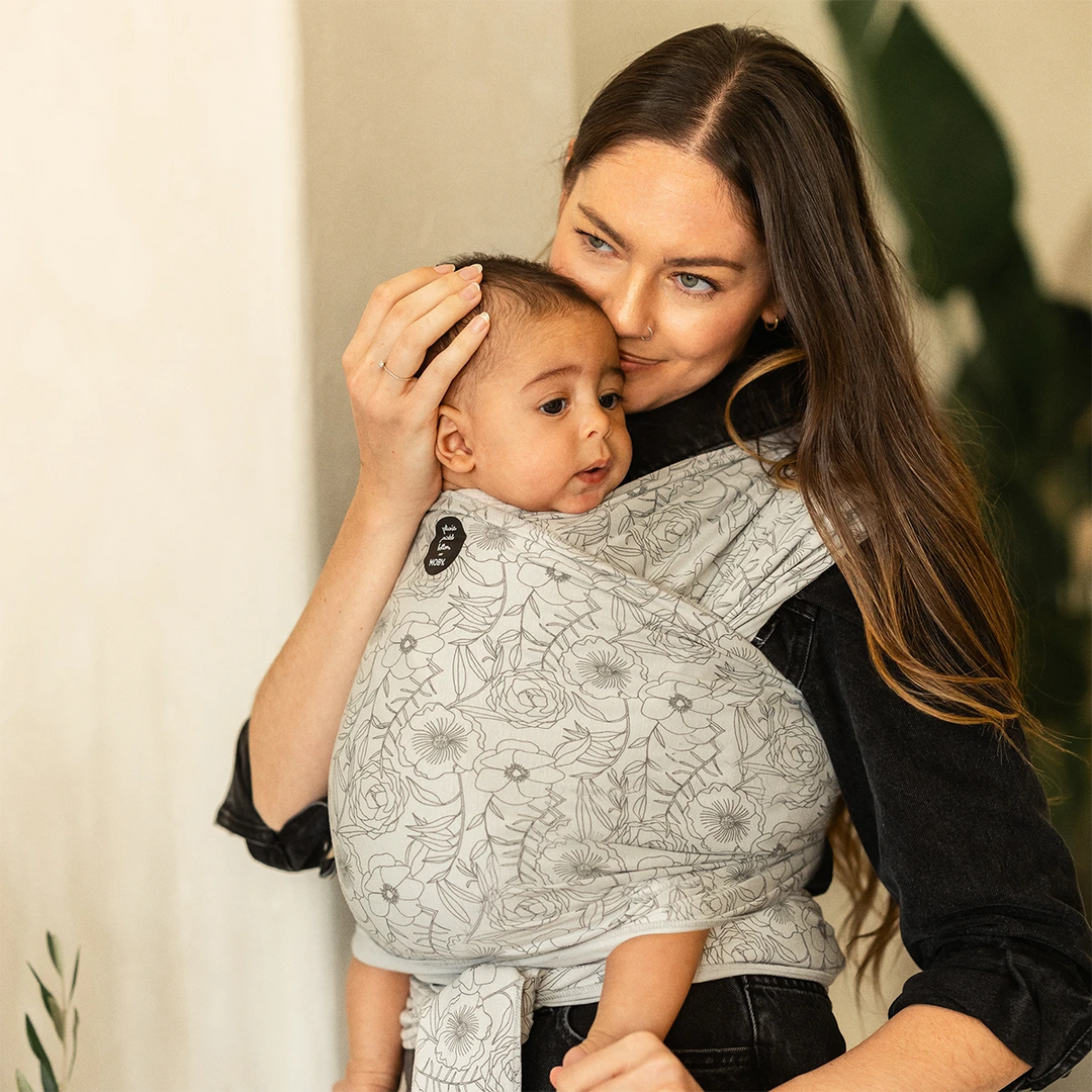 mom wearing baby in Classic Wrap Baby Carrier by Petunia Pickle Bottom in Seaside Poppies