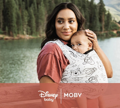disney baby and moby. mom wearing baby in featherknit wrap in winnie the pooh and pals