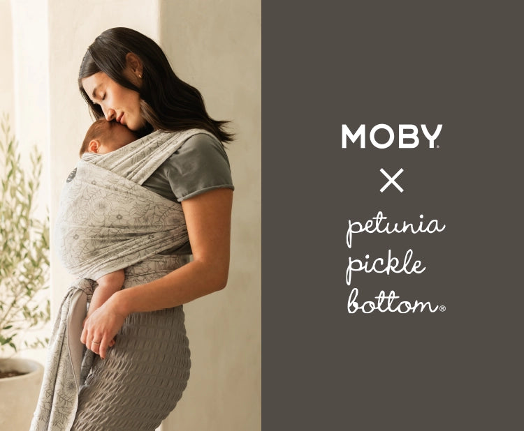 moby and petunia pickle bottom. mom wearing baby in classic wrap in seaside poppies