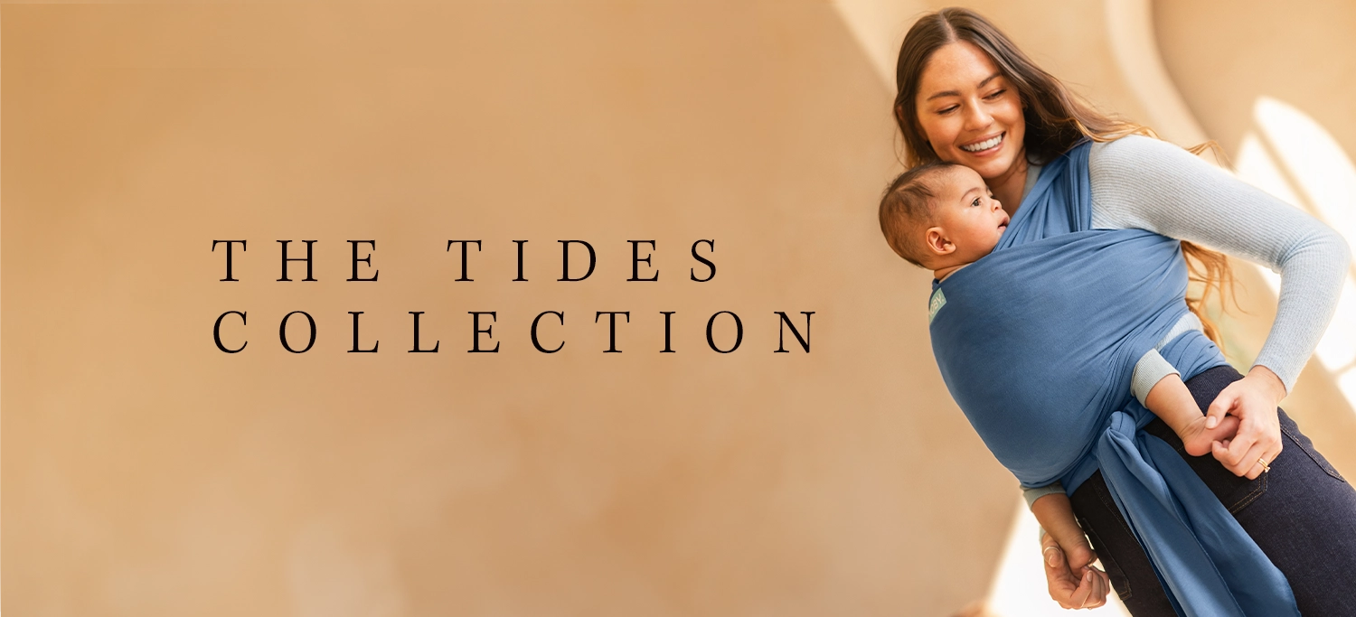 the new moby tides collection of wraps featuring mom wearing ocean blue baby wrap carrier with infant