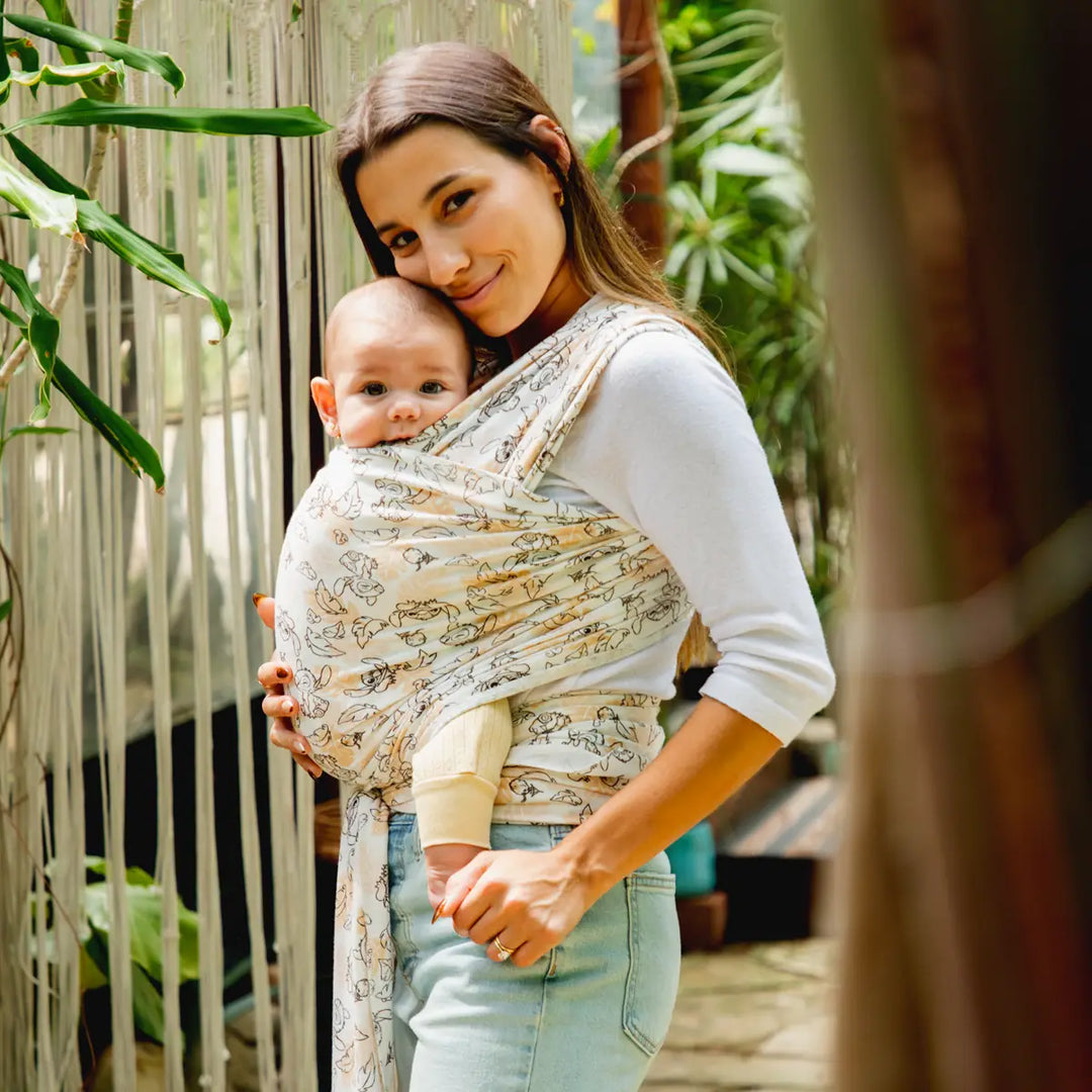 mom wearing baby in disney's aloha stitch moby wrap