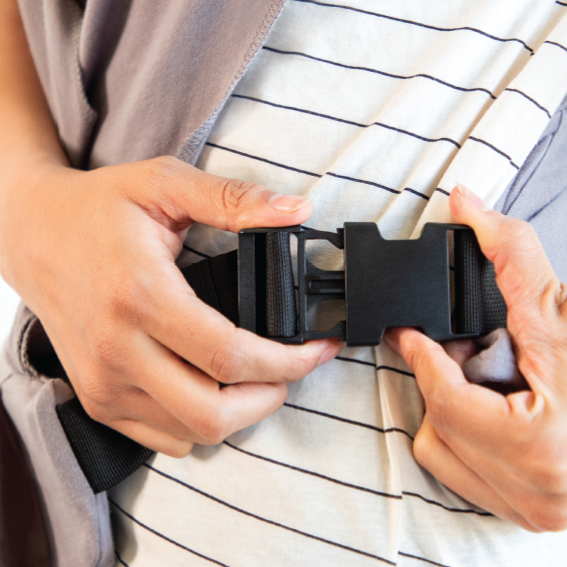 woman clasping sturdy plastic buckles