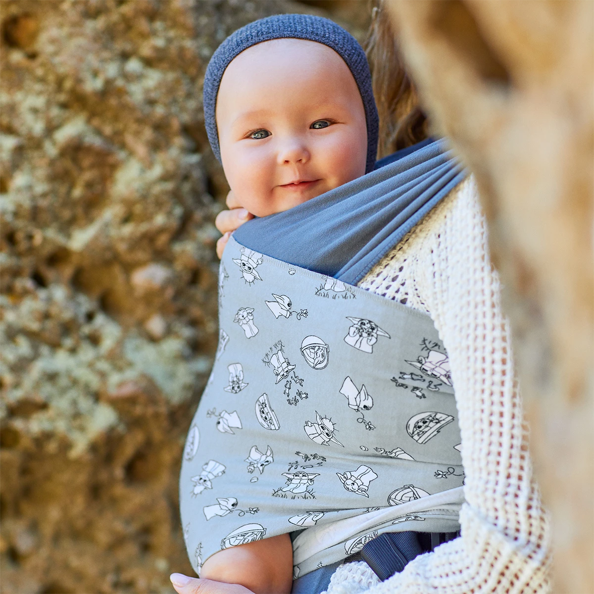 close up image of Mom wearing baby in Easy-Wrap Carrier in Grogu’s Galaxy