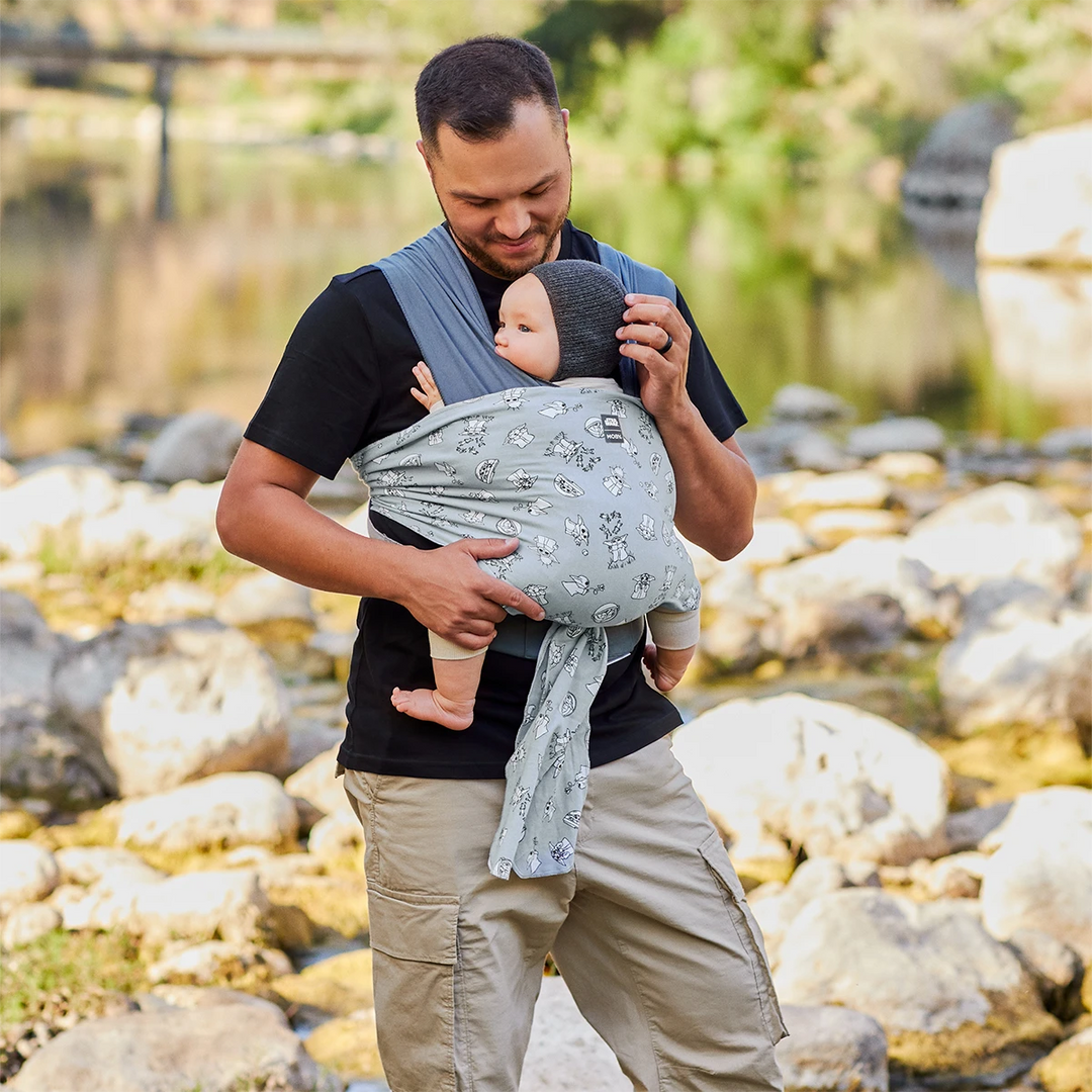 Dad wearing baby in Easy-Wrap Carrier in Grogu’s Galaxy