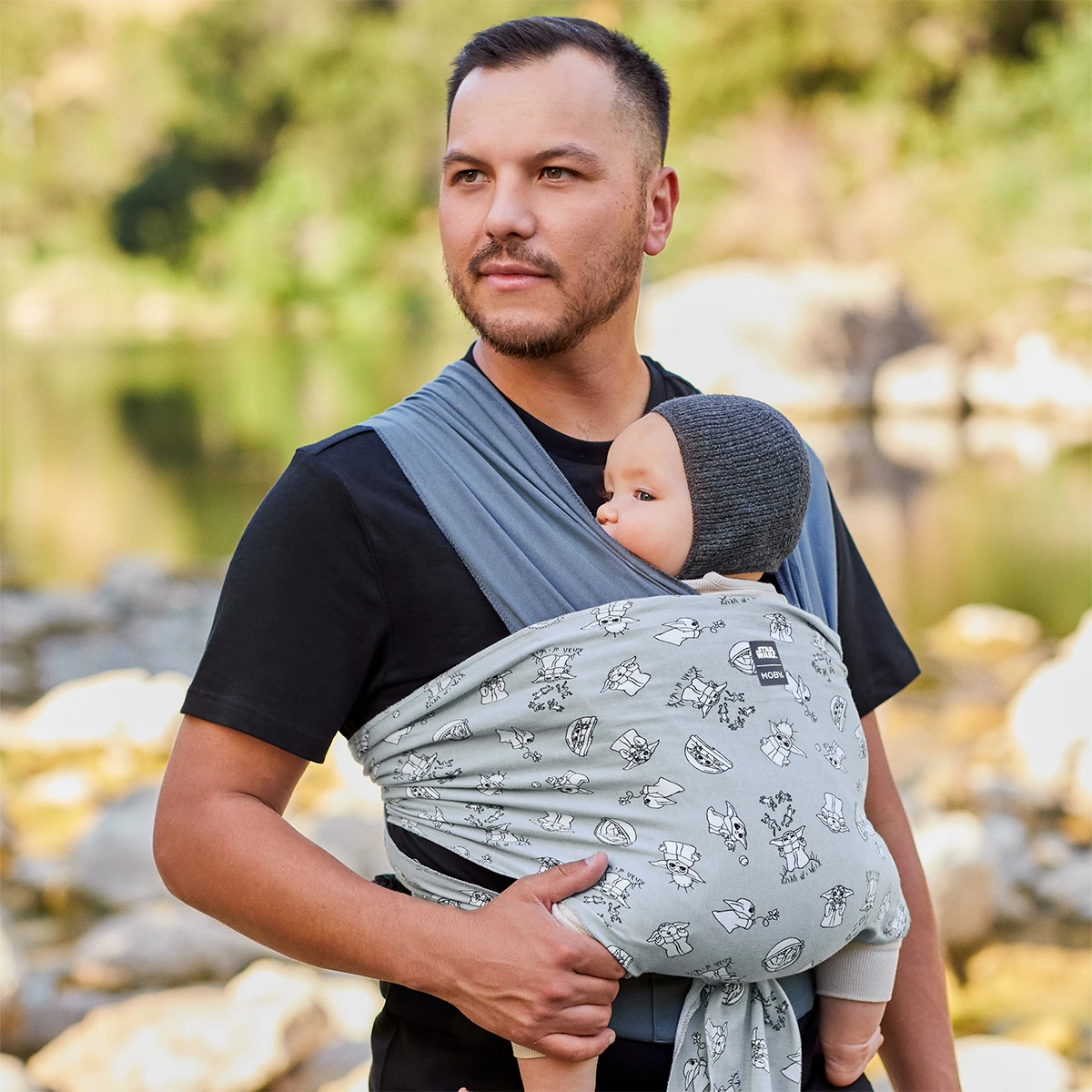 Dad wearing baby in Easy-Wrap Carrier in Grogu’s Galaxy