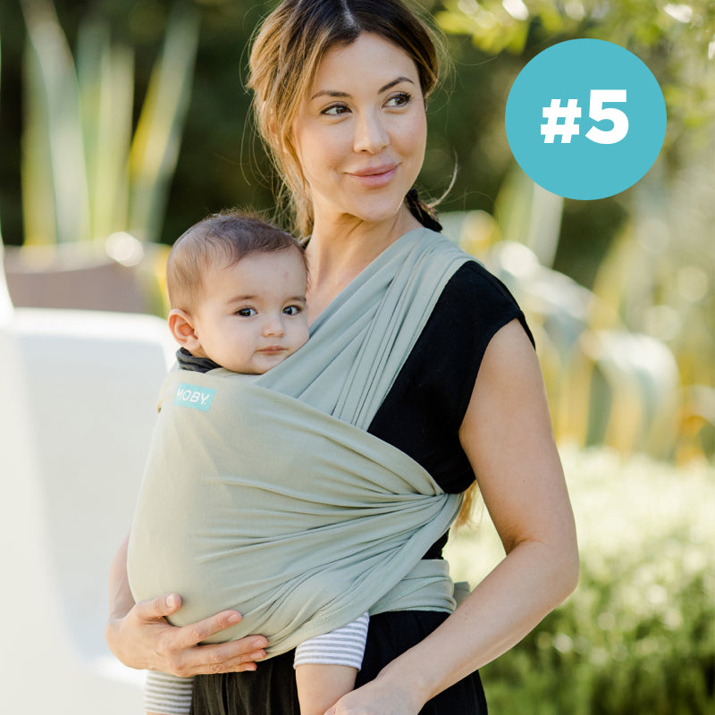 #5 Moby Best Seller. Mom wearing baby in classic wrap in pear