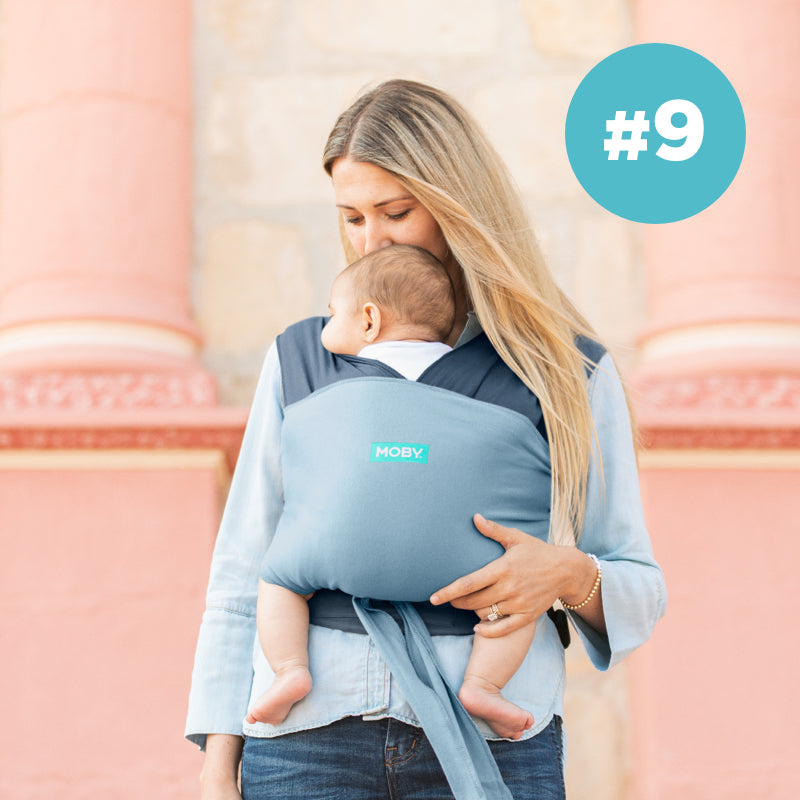#9 Moby Best Seller. Mom wearing baby in easy wrap in sea spray blue