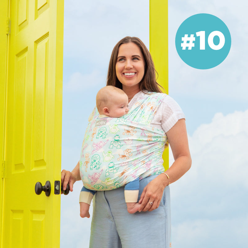 #10 Moby Best Seller. Mom wearing baby in fefatherknit wrap in toy story