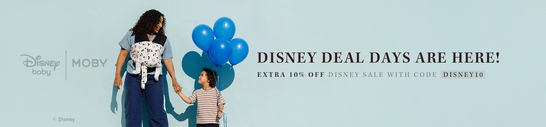 disney deal days are here! extra 10% off disney sale with code disney10. mom wearing baby in disney easy wrap