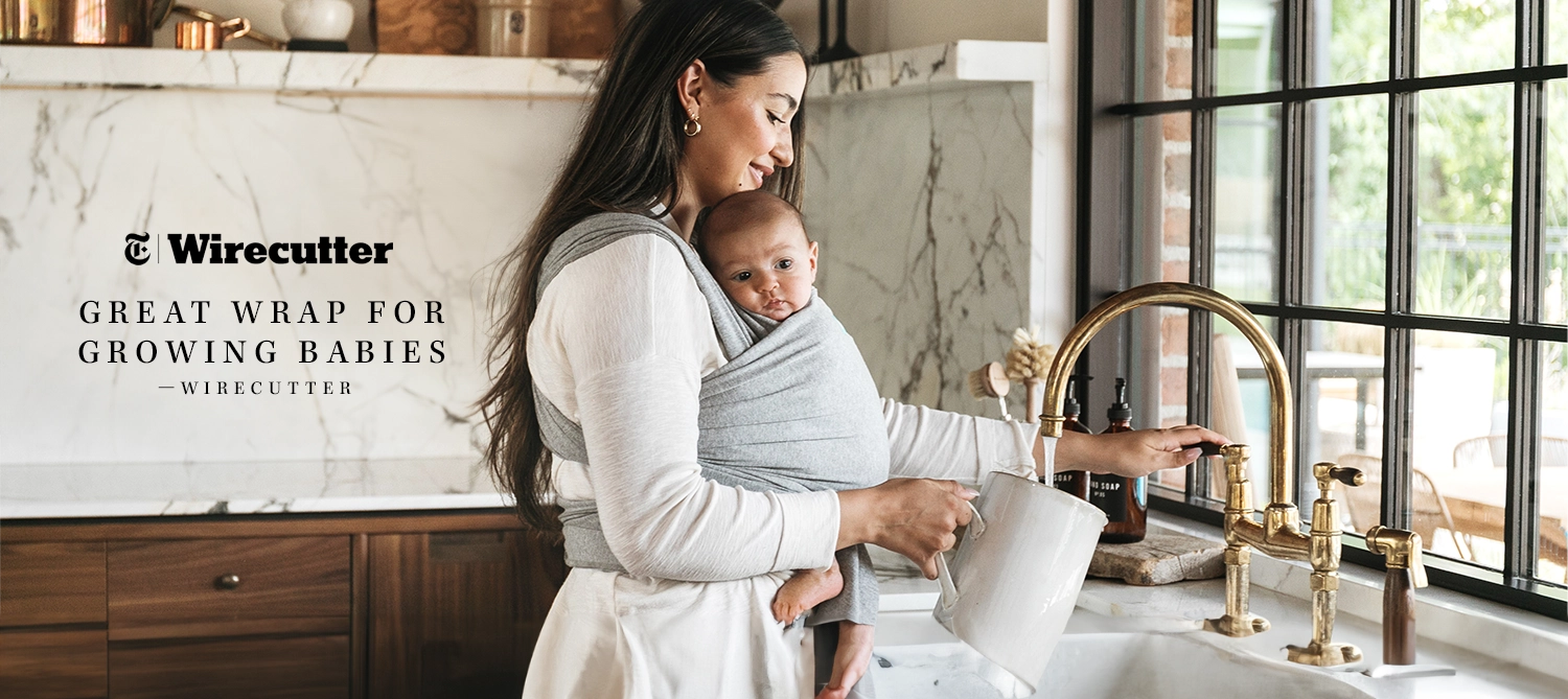 great wrap for growing babies by wirecutter. mom wearing baby in moby wrap in grey