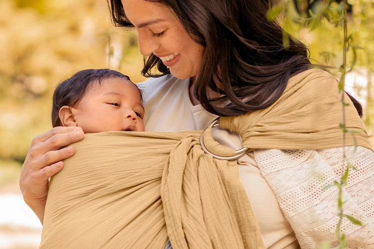 mom wearing baby in ring sling