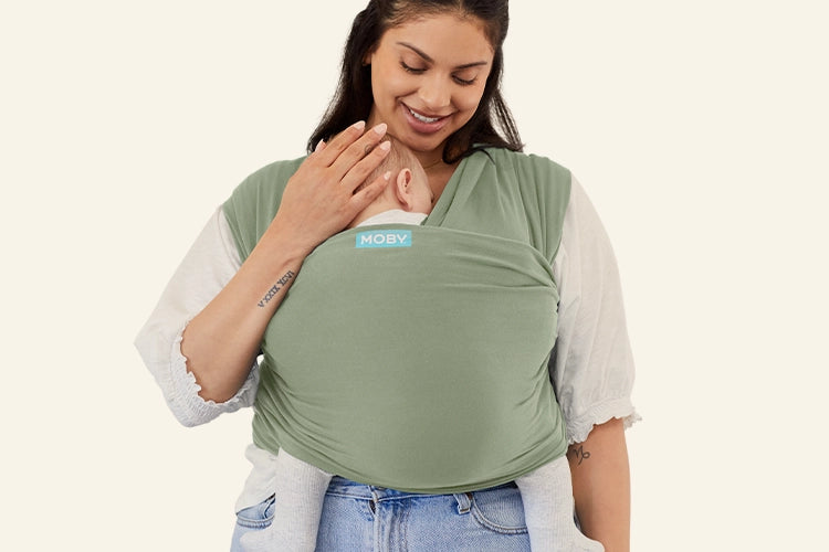 plus size mom wearing green baby wrap carrier