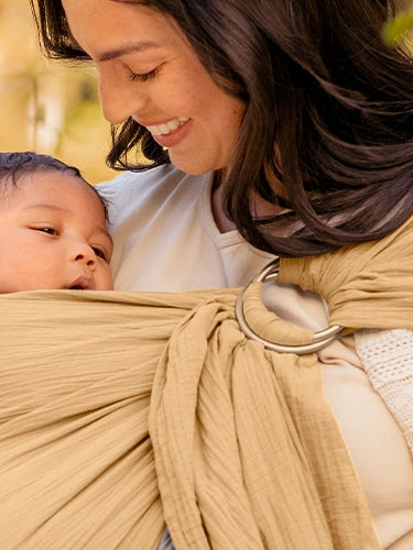 mom wearing baby in ring sling